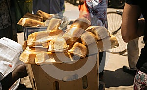 Spontaneous African market. Aframerican sells bread  the local market