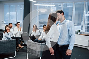 Spontaneous lovely kiss between two employees shocked other office workers