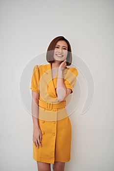 Spontaneously laughing relaxed young pretty casual woman standing portrait  over white background