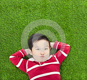 A spoof expression kid lying and holding his head photo
