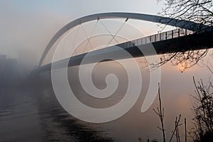 Spooky atmosphere due to fog in downtown Maastricht with a view on the hoge brug