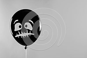 Spooky balloon for Halloween party on light grey, space for text