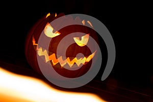 Spooky carved halloween pumpkin in hot burning hell fire flames