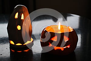 Spooky Halloween candlelights in a shape of a jack-o-lantern and ghost