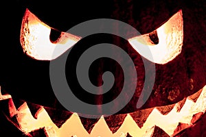 Spooky halloween pumpkin smile with hot burning fire eyes mouth