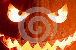 Spooky halloween pumpkin smile with hot burning fire eyes mouth