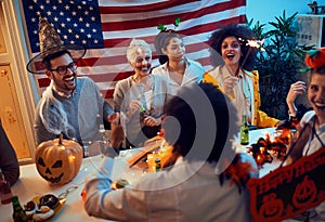 Spooky happy people in costumes at Halloween Party