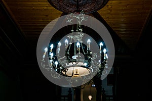 Spooky lit chandelier with glowing white light