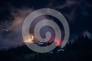 Spooky mediaeval castle in St. Martin in Thurn, hidden behind low hanging clouds, South Tirol