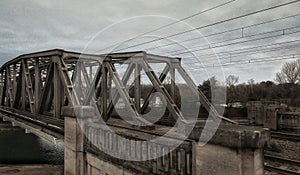 Spooky old metal bridge with stormy clouds photo