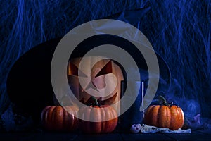 Spooky pumpkin for Halloween. Black candle and ominous smoke