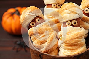 Spooky sausage mummies for Halloween party served on table, closeup