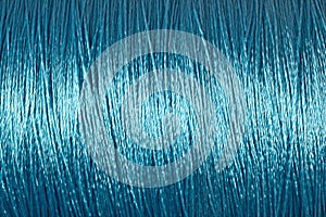 Spool of blue thread macro background