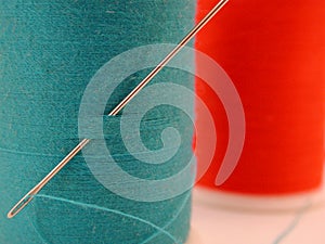 Spool of blue thread with needle