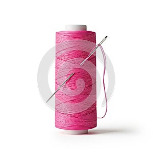 A spool of bright pink thread with a silver needle inserted through the thread on a white background