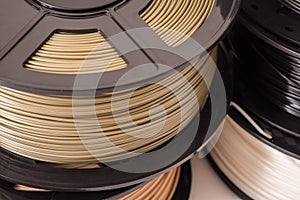 Spool of bronze PLA plastic filament for 3D printer.