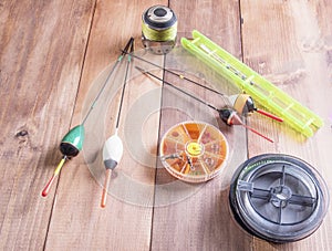 spool of fishing line, floats and a box of hooks