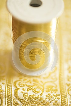 Spool of Gold-Colored Thread