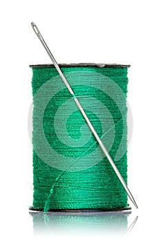 Spool of green thread with needle