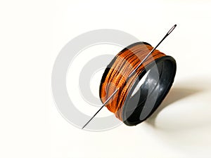 sewing needle with thread on white background