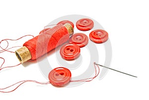 Spool of red thread and buttons