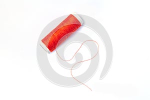 Spool of red thread isolated on white background