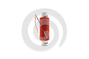 Spool of red thread with a needle isolated on white background. Red thread and needle isolated on white background