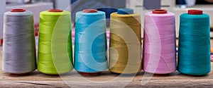 Spool of sewing thread. Multicolor sewing threads. Colored sewing threads.