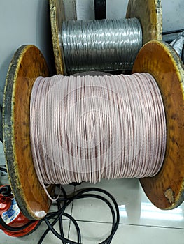 spool of small cable in the factory, closeup of photo.