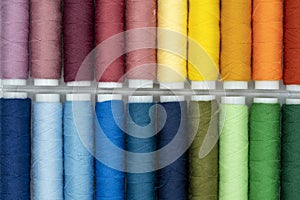 Spool of thread many of different colors isolated on white