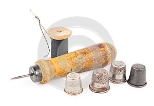 Spool of thread with needle and awl