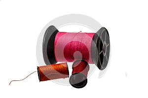 Spool thread and needle isolated on white background .
