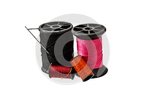 Spool thread and needle isolated on white background .