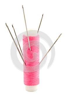 Spool of thread with needle isolated on white