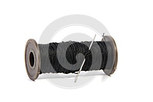 Spool of thread and needle isolated on white