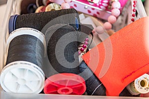Spool of Thread and Needle, red spool of thread mounted on the sewing machine