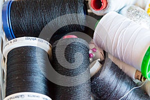 Spool of Thread and Needle, red spool of thread mounted on the sewing machine