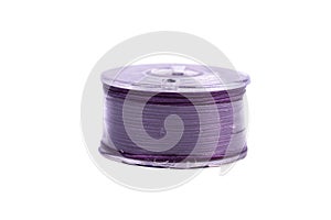 A spool of thread from a sewing machine on a white background isolated