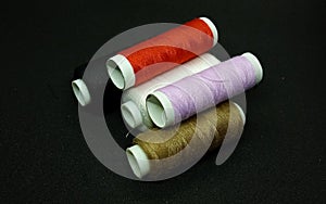 Spool threads isolated on the black background.