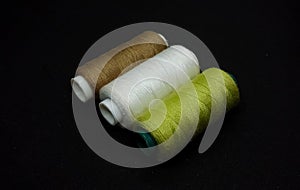 Spool threads isolated on the black background.