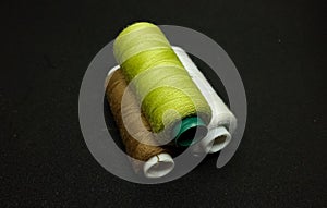 Spool threads isolated on the black background.