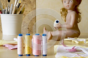 Spool of threads with sewing supplies as a background