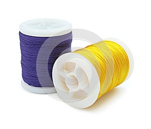 Spool of yellow and blue thread, Bobbins thread, Material of sewing tool, Isolated on white background