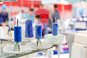 Spools of blue threads on sewing machine, closeup