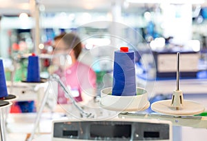 Spools of blue threads on sewing machine, factory