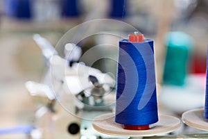 Spools of blue threads on sewing machine, factory