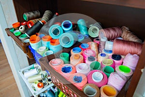 Spools and bobbins with multi-colored threads