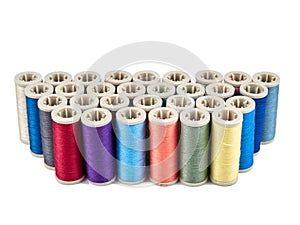 Spools with colored sewing thread on white background