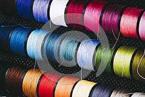 Spools of colorful cotton threads for sewing