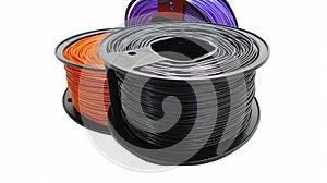 Spools of colorful filament in orange, purple, and black for use in 3D printing technology photo